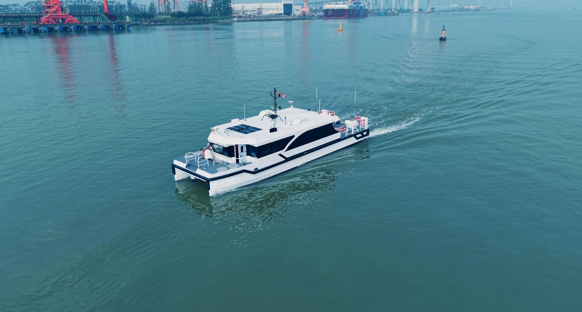 OBLUE SHUTTLE 18E all-electric carbon fiber catamaran underway, aerial view