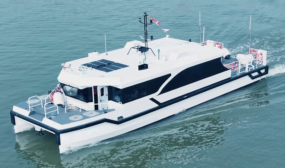 OBLUE SHUTTLE 18E close aerial view — rooftop solar array, mast and open stern cargo deck