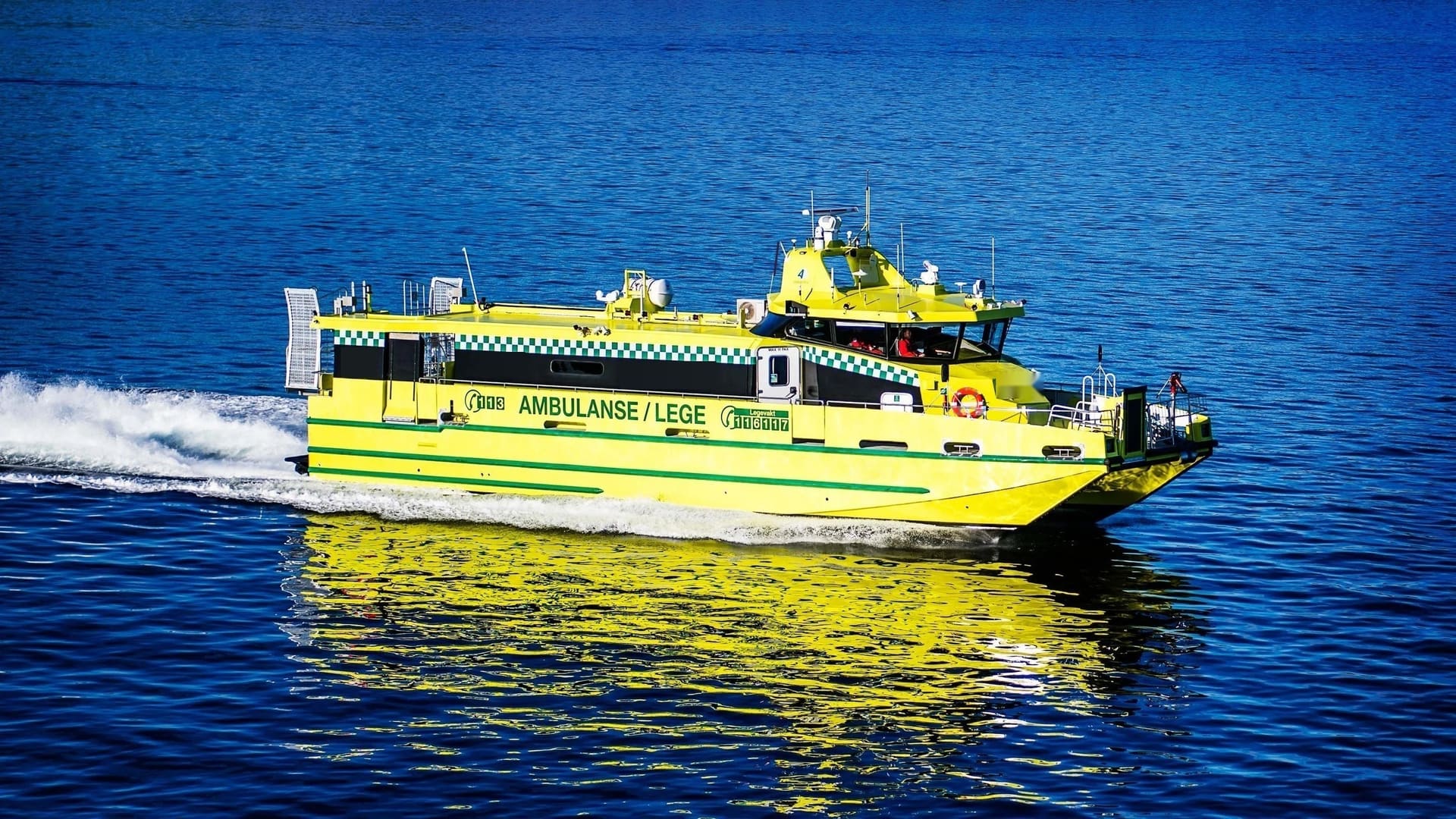 OBLUE MEDIC 22 ambulance catamaran underway at speed, high-visibility yellow livery